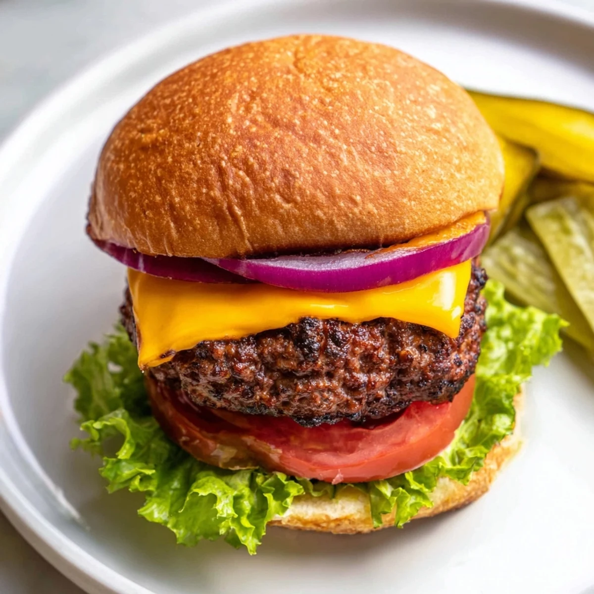 Homemade hamburgers stacked high with fresh ingredients, ready to be enjoyed with a side of fries.