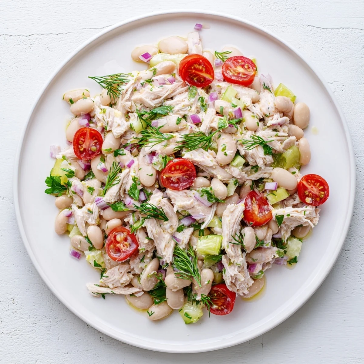 Tender chicken, creamy white beans, and crisp celery are tossed in a bright lemon vinaigrette for a refreshing Lemony White Bean Chicken Salad.