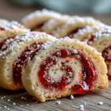 Freshly baked Raspberry Swirl Shortbread Cookies show visible jam swirls and a dusting of sugar, ideal for homemade gifting.