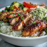 Sliced BBQ Chicken Bowl topped with crisp, creamy coleslaw and tender roasted zucchini, broccoli, and red onion makes a hearty weeknight dinner.