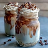 Vanilla Bean Frappuccino Overnight Oats Jar with creamy layers and whipped cream topping, served in a glass jar.