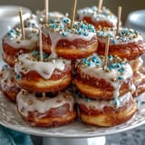 Visually stunning donut tower celebrating with friends, topped with festive sprinkles.