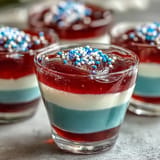 Festive 4th of July Firecracker Jello Shots layered with vibrant red, white, blue colors.