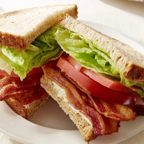Crispy bacon, fresh tomato, and lettuce create a flavorful BLT sandwich on toasted bread.