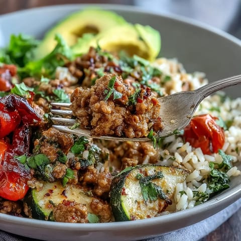 Fork-tender ground turkey and roasted broccoli on brown rice in a colorful bowl.